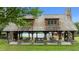 Outdoor pavilion with stone pillars, picnic tables, and a view of the lake at 310 Hidden Lake Dr, Youngsville, NC 27596
