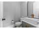 Stylish powder room featuring a modern sink, black fixtures, and a round black mirror at 310 Hidden Lake Dr, Youngsville, NC 27596