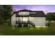 Back view of a charming home with a screened porch and well-maintained lawn at twilight at 310 Hidden Lake Dr, Youngsville, NC 27596