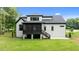 Rear view of a home with a screened porch overlooking a well-manicured lawn, perfect for outdoor living at 310 Hidden Lake Dr, Youngsville, NC 27596