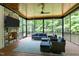 Cozy screened-in porch with wood ceiling, stone fireplace and comfortable seating area with views at 310 Hidden Lake Dr, Youngsville, NC 27596