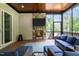 Relax in this screened-in sunroom with a stone fireplace and comfortable seating overlooking the lush backyard at 310 Hidden Lake Dr, Youngsville, NC 27596