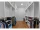 Spacious walk-in closet with custom shelving, wood floors, and ample storage for organization at 310 Hidden Lake Dr, Youngsville, NC 27596