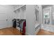 Large walk-in closet offering custom shelves, bench and a view into the bathroom with marble flooring at 310 Hidden Lake Dr, Youngsville, NC 27596