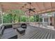 Relaxing back porch featuring ceiling fan and wooded views at 3205 Dell Dr, Raleigh, NC 27609