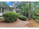 A tranquil backyard with a covered porch, a tree house, and an abundance of natural foliage at 3205 Dell Dr, Raleigh, NC 27609