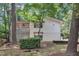 Backyard view of house with well-manicured landscaping and privacy fence at 3205 Dell Dr, Raleigh, NC 27609