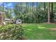 An expansive backyard featuring a shed, trampoline, seating area, and lush landscaping creating a private outdoor oasis at 3205 Dell Dr, Raleigh, NC 27609