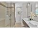 Bathroom with large, glass-door shower, dual sinks, and modern fixtures at 3205 Dell Dr, Raleigh, NC 27609