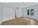 Light-filled bedroom with hardwood floors, closet, and window views at 3205 Dell Dr, Raleigh, NC 27609