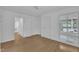 White bedroom featuring hardwood floors and natural light at 3205 Dell Dr, Raleigh, NC 27609