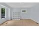 Bedroom with hardwood floors, natural light, and closet shelving at 3205 Dell Dr, Raleigh, NC 27609