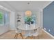 Bright dining room with a modern chandelier and a view to the outdoor patio at 3205 Dell Dr, Raleigh, NC 27609
