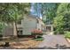 Exterior of home with ample windows, a driveway and well-maintained landscaping at 3205 Dell Dr, Raleigh, NC 27609