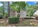 An exterior side view shows the home's architecture, with landscaping and an elevated porch at 3205 Dell Dr, Raleigh, NC 27609