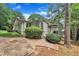 An exterior side view shows the home's architecture, with landscaping, a fire pit, and an elevated porch at 3205 Dell Dr, Raleigh, NC 27609