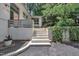 Close up of the home's entrance with brick steps, inviting landscape, and manicured garden at 3205 Dell Dr, Raleigh, NC 27609