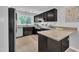 Modern kitchen featuring granite counters, stainless steel appliances, and a bright window at 3205 Dell Dr, Raleigh, NC 27609