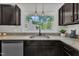 Well lit kitchen showing granite counters, view of backyard and modern appliances at 3205 Dell Dr, Raleigh, NC 27609