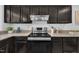 Well-equipped kitchen featuring stainless steel appliances and dark wood cabinets at 3205 Dell Dr, Raleigh, NC 27609