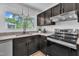 Close up of the kitchen area with granite countertops, a view to outside and modern appliances at 3205 Dell Dr, Raleigh, NC 27609