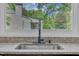 Modern kitchen sink with granite countertops and a window view of the backyard at 3205 Dell Dr, Raleigh, NC 27609