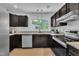 Bright kitchen featuring modern appliances, granite countertops, and ample storage at 3205 Dell Dr, Raleigh, NC 27609