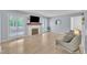 Bright living room with a brick fireplace and large windows at 3205 Dell Dr, Raleigh, NC 27609