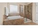Bathroom features tub with tiled surround, shower, and ample lighting at 3312 Flat River Dr, Durham, NC 27703