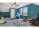 Bedroom featuring a play area, comfortable rocking chair, and plenty of natural light at 3312 Flat River Dr, Durham, NC 27703