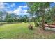 Well-maintained lawn, mature trees, and wooden fence for added privacy at 35 Stratton Ct, Youngsville, NC 27596
