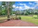 Relaxing backyard deck with built-in bench seating overlooking a spacious, well-maintained lawn and mature trees at 35 Stratton Ct, Youngsville, NC 27596