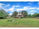 Spacious backyard featuring a lush lawn, mature trees, shed, and a charming fire pit area, perfect for outdoor enjoyment at 35 Stratton Ct, Youngsville, NC 27596