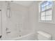 Bathroom featuring a tub and shower combination, window, and toilet at 35 Stratton Ct, Youngsville, NC 27596