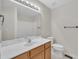 Bathroom featuring a single sink, wood cabinets, and large mirror at 35 Stratton Ct, Youngsville, NC 27596