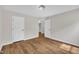 Bedroom featuring wood-look floors and two doors to closets, all painted in neutral tones at 35 Stratton Ct, Youngsville, NC 27596