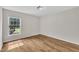 Bedroom with wood-look floors, neutral walls, a window, and a modern light fixture at 35 Stratton Ct, Youngsville, NC 27596