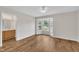 Bedroom featuring wood-look floors, ceiling fan, and bay window, with attached bathroom at 35 Stratton Ct, Youngsville, NC 27596