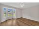 Bedroom featuring wood-look floors and a large bay window with a view to the neighborhood at 35 Stratton Ct, Youngsville, NC 27596