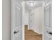 Hallway view with hardwood floors and white doors at 35 Stratton Ct, Youngsville, NC 27596