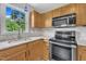 Close-up of kitchen sink with granite counters and stainless appliances at 35 Stratton Ct, Youngsville, NC 27596