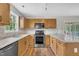 Galley kitchen with stainless steel appliances and mosaic backsplash at 35 Stratton Ct, Youngsville, NC 27596