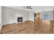 Spacious living room with hardwood floors, a cozy fireplace, and seamless access to the kitchen and outdoor area at 35 Stratton Ct, Youngsville, NC 27596