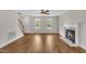 Bright living room featuring a cozy fireplace and two sunlit windows at 35 Stratton Ct, Youngsville, NC 27596