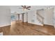 Open living space with sleek floors, a rustic sliding barn door, and staircase, creating a blend of modern and traditional styles at 35 Stratton Ct, Youngsville, NC 27596