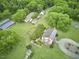 Expansive property aerial view with main house, outbuildings, mature trees and verdant lawns at 3679 Oak Lawn Farm Rd, Oxford, NC 27565