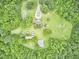 Bird's eye view of private estate surrounded by lush greenery, manicured lawn and gardens at 3679 Oak Lawn Farm Rd, Oxford, NC 27565