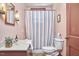 Cozy bathroom showcasing classic fixtures, decorative mirror, and a patterned shower curtain at 3679 Oak Lawn Farm Rd, Oxford, NC 27565
