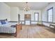 Expansive bedroom with hardwood flooring, fire place, and a vintage chandelier at 3679 Oak Lawn Farm Rd, Oxford, NC 27565