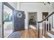 Inviting entryway with hardwood floors, a wreath on the front door, and staircase at 3679 Oak Lawn Farm Rd, Oxford, NC 27565